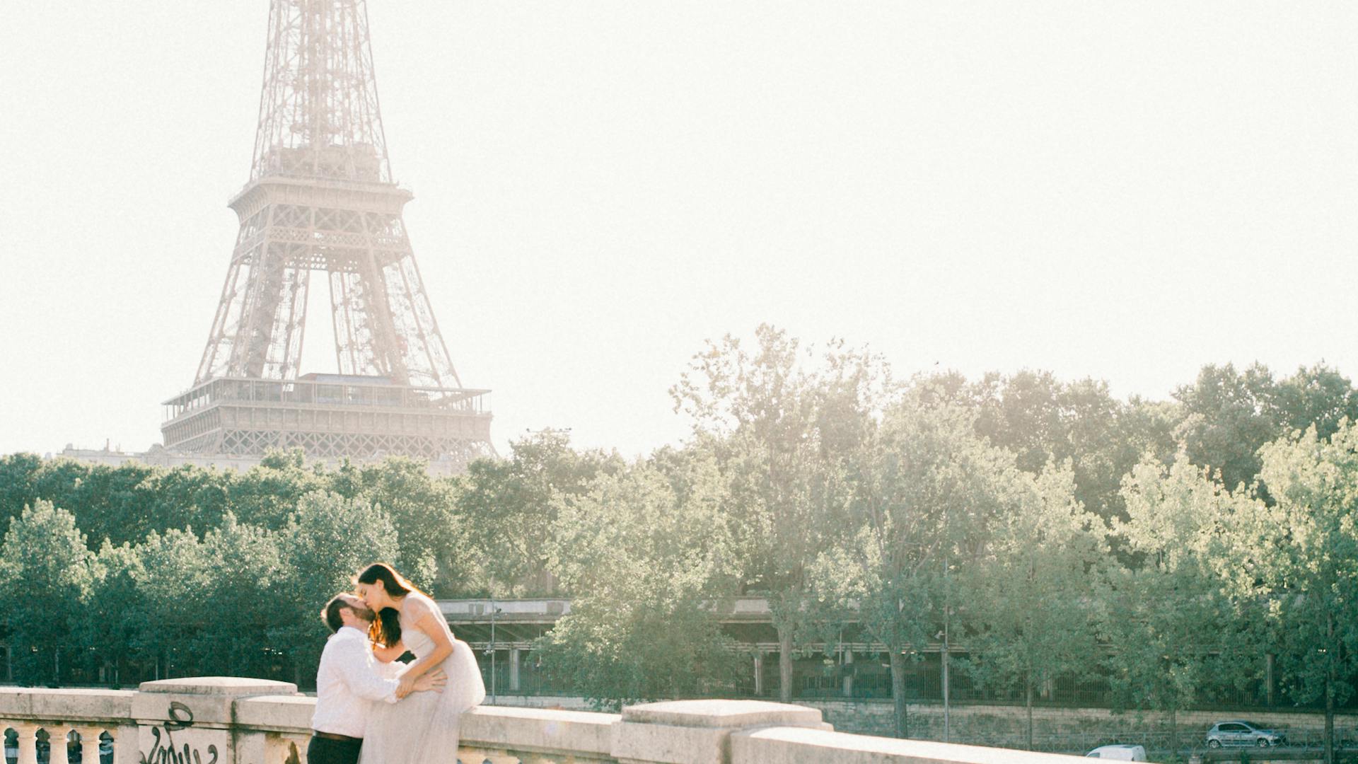 Paris wedding ceremony - couple kissing by Eiffel Tower
